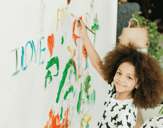 kid painting on wall