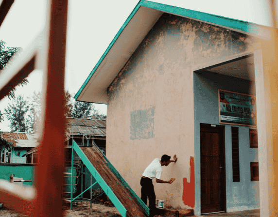 person painting outside walls