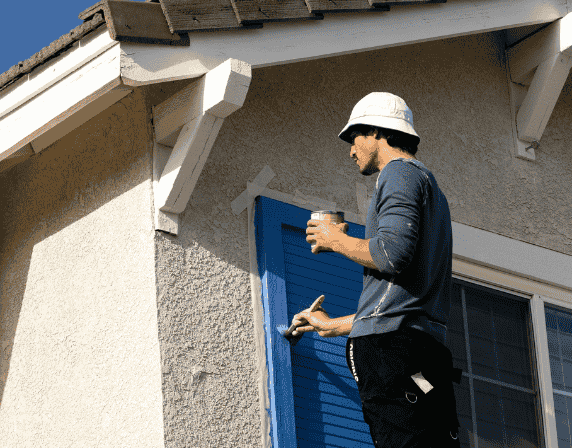 person painting walls