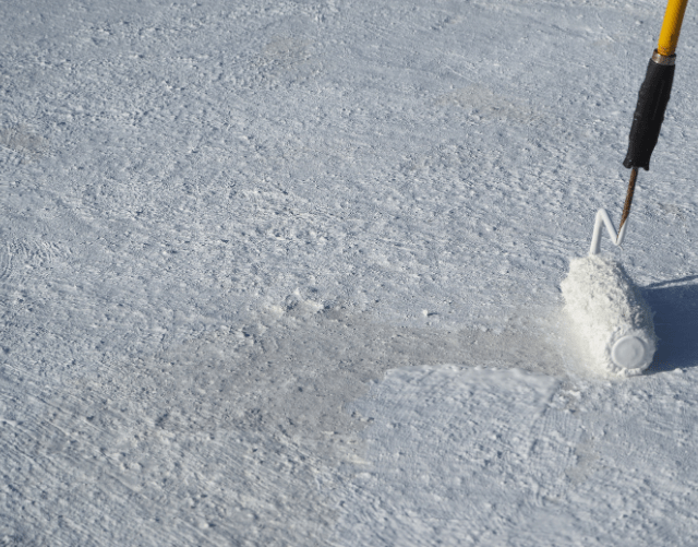 white paint roller on roof